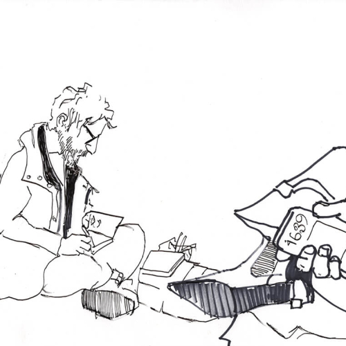 A black and white drawing shows a person with glasses sitting cross-legged, writing in a notebook. In the foreground, a hand holds a phone displaying the number 1699. Various papers and objects surround the scene.